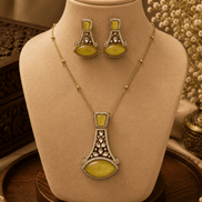 Gold-tone pendant necklace set with yellow-green teardrop earrings and central pendant