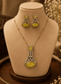 Gold-tone pendant necklace set with yellow-green teardrop earrings and central pendant