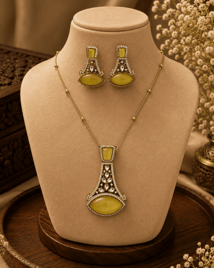 Gold-tone pendant necklace set with yellow-green teardrop earrings and central pendant