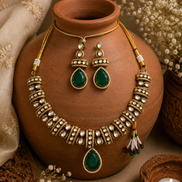 Gold-tone heritage necklace set with green teardrop pendant and matching drop earrings