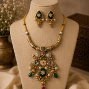 Gold-tone necklace set with green enamel center and pearl drops, matching green earrings
