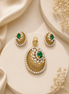 Gold-tone pendant with green oval halo and matching stud earrings