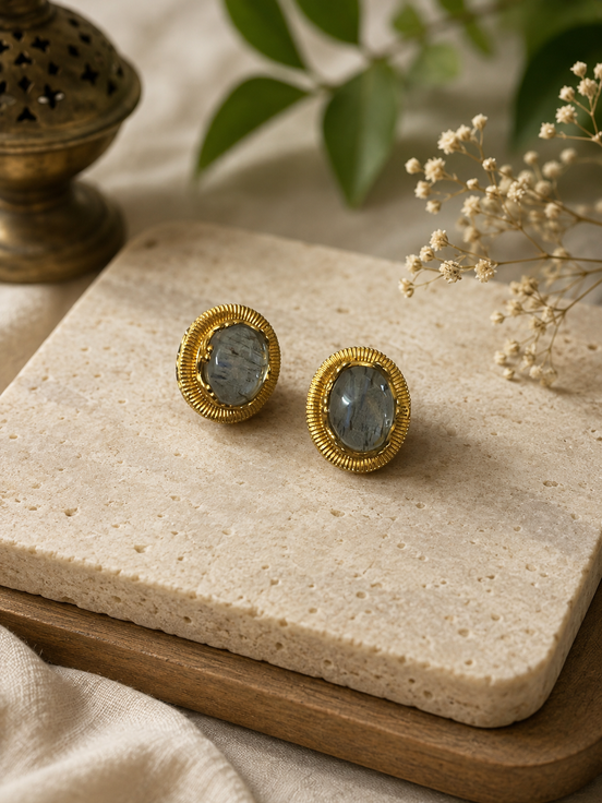 Oval grey stone stud earrings with gold-tone ridged bezel