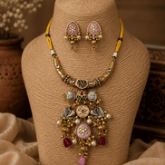 Gold-tone necklace set with green stones and pink enamel accents, plus pink stud earrings