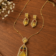 Gold-tone gemstone pendant necklace set with red and teal diamond drops