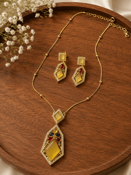 Gold-tone gemstone pendant necklace set with red and teal diamond drops
