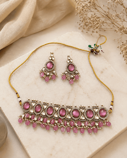 Dusty rose choker and earrings set on tray, gold-tone chain with pink teardrop charms