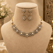 Peach pink stone necklace with floral bib design and matching dangling earrings