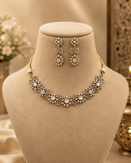 Peach pink stone necklace with floral bib design and matching dangling earrings