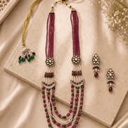 Ruby pink layered beaded necklace with tassel drops and matching stud earrings