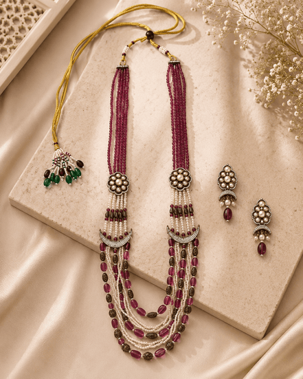 Ruby pink layered beaded necklace with tassel drops and matching stud earrings
