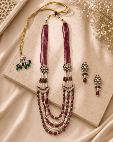 Ruby pink layered beaded necklace with tassel drops and matching stud earrings