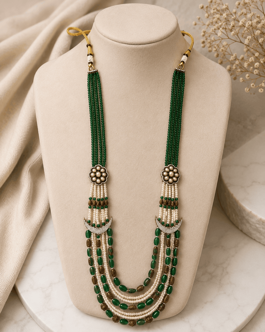 Teal green layered beaded necklace with tassel drops and gold flower stud earrings