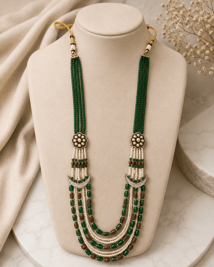 Teal green layered beaded necklace with tassel drops and gold flower stud earrings