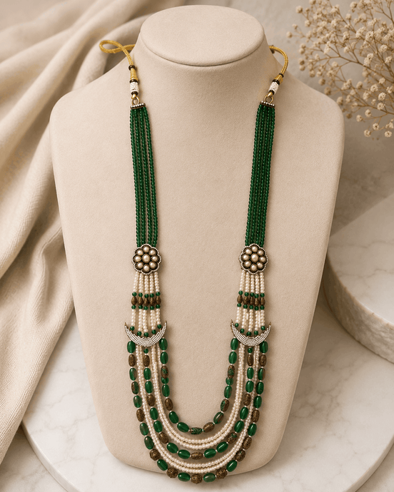 Teal green layered beaded necklace with tassel drops and gold flower stud earrings
