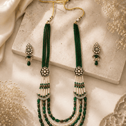 Teal green layered beaded necklace set with tassel ends and matching stud earrings
