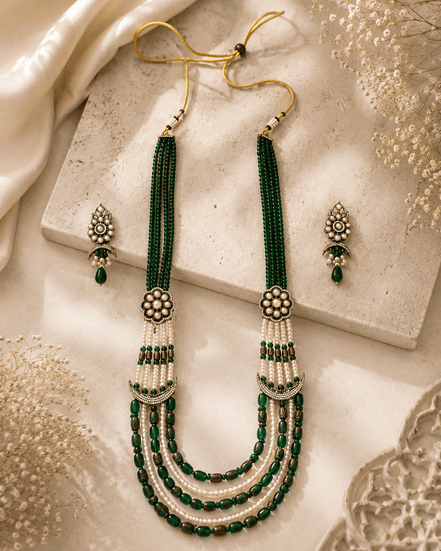 Teal green layered beaded necklace set with tassel ends and matching stud earrings