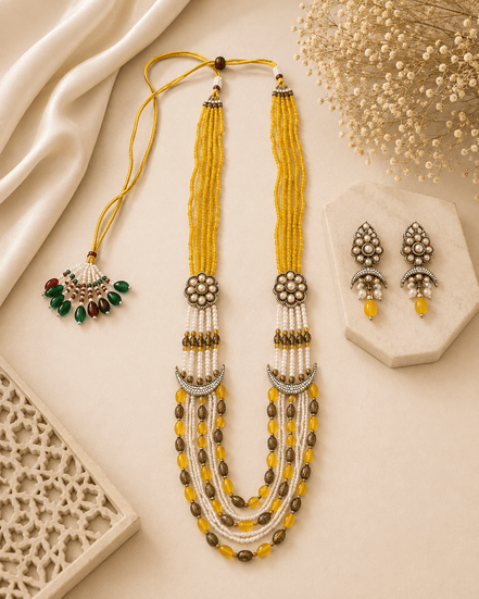 Gold layered beaded necklace set with green-red drops and matching stud earrings