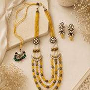 Gold layered beaded necklace with tassel drops and matching stud earrings