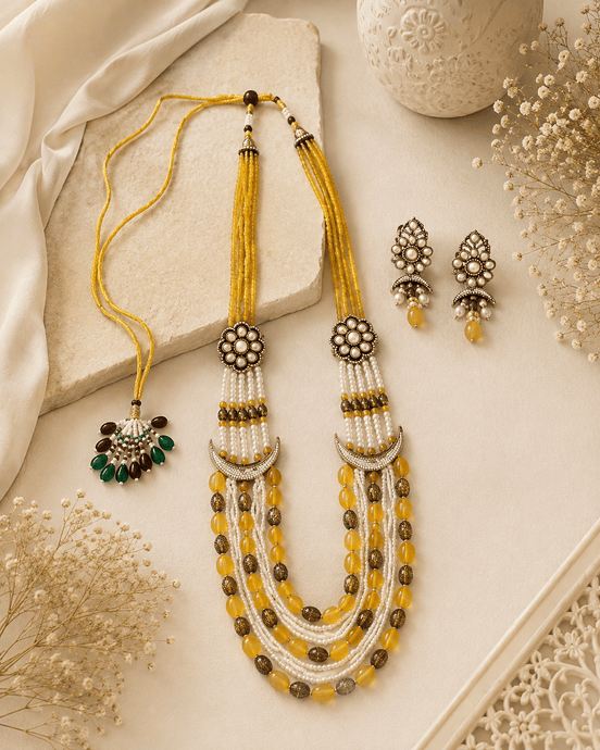 Gold layered beaded necklace with tassel drops and matching stud earrings