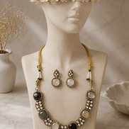 Gold-tone gemstone necklace with blue center stone, mixed round beads, and drop stud earrings