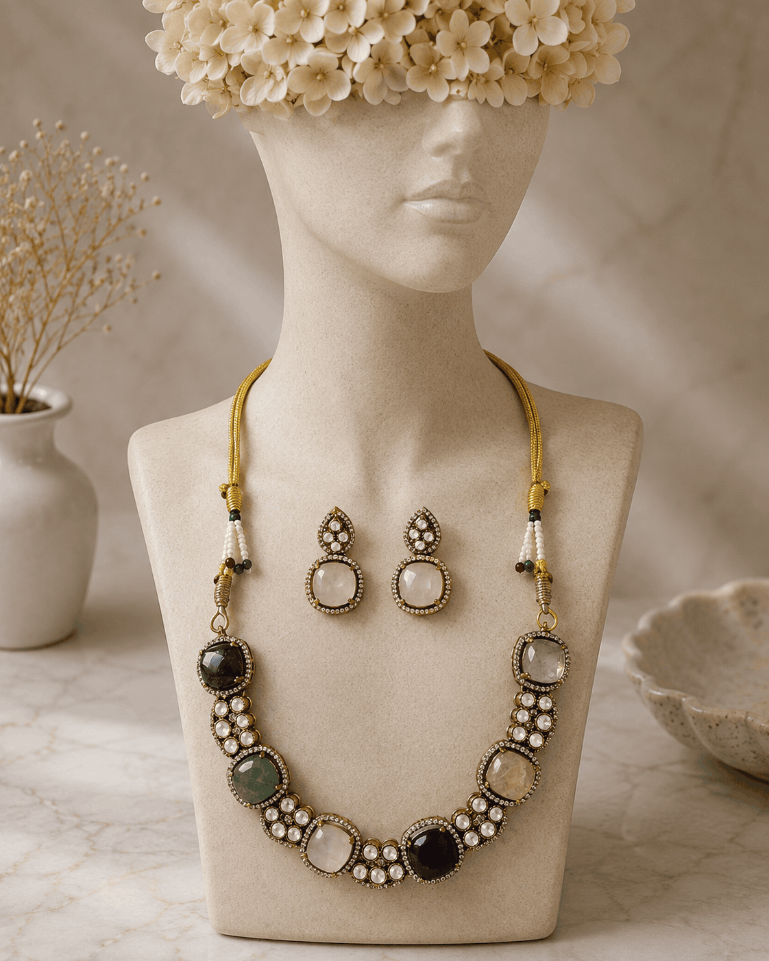 Gold-tone gemstone necklace with blue center stone, mixed round beads, and drop stud earrings