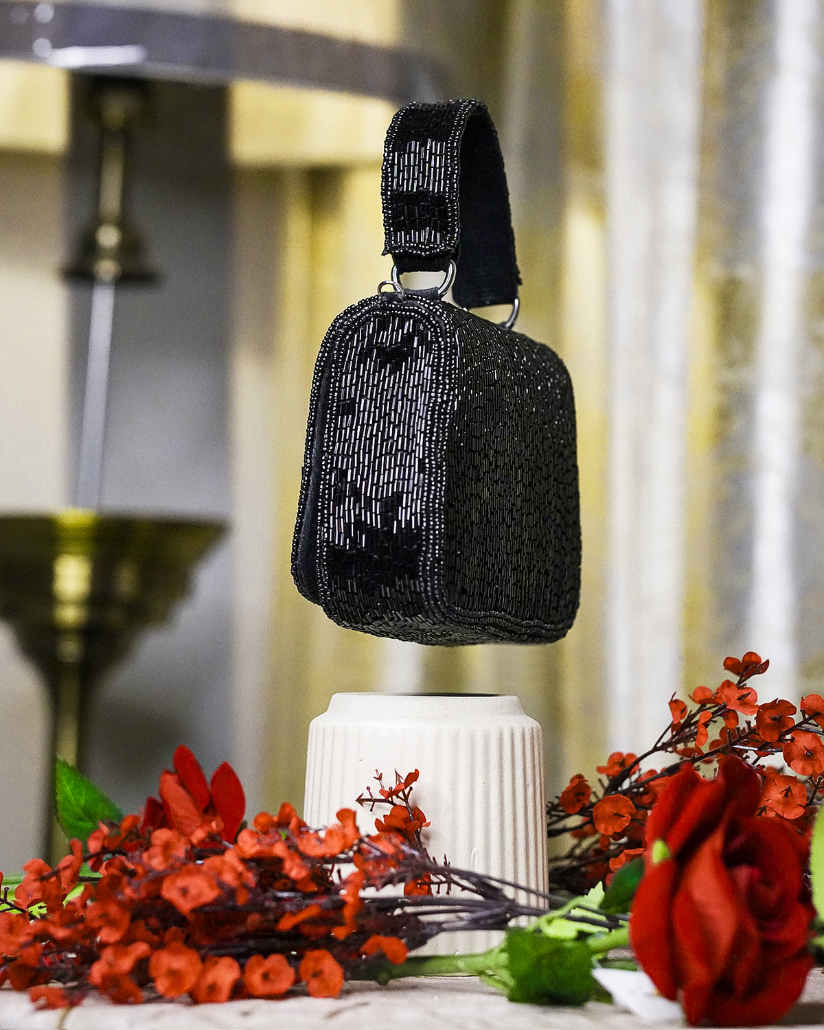 Black crystal mini bag with top handle and faceted beaded texture