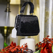 Black crystal mini bag with top handle and small hanging tag