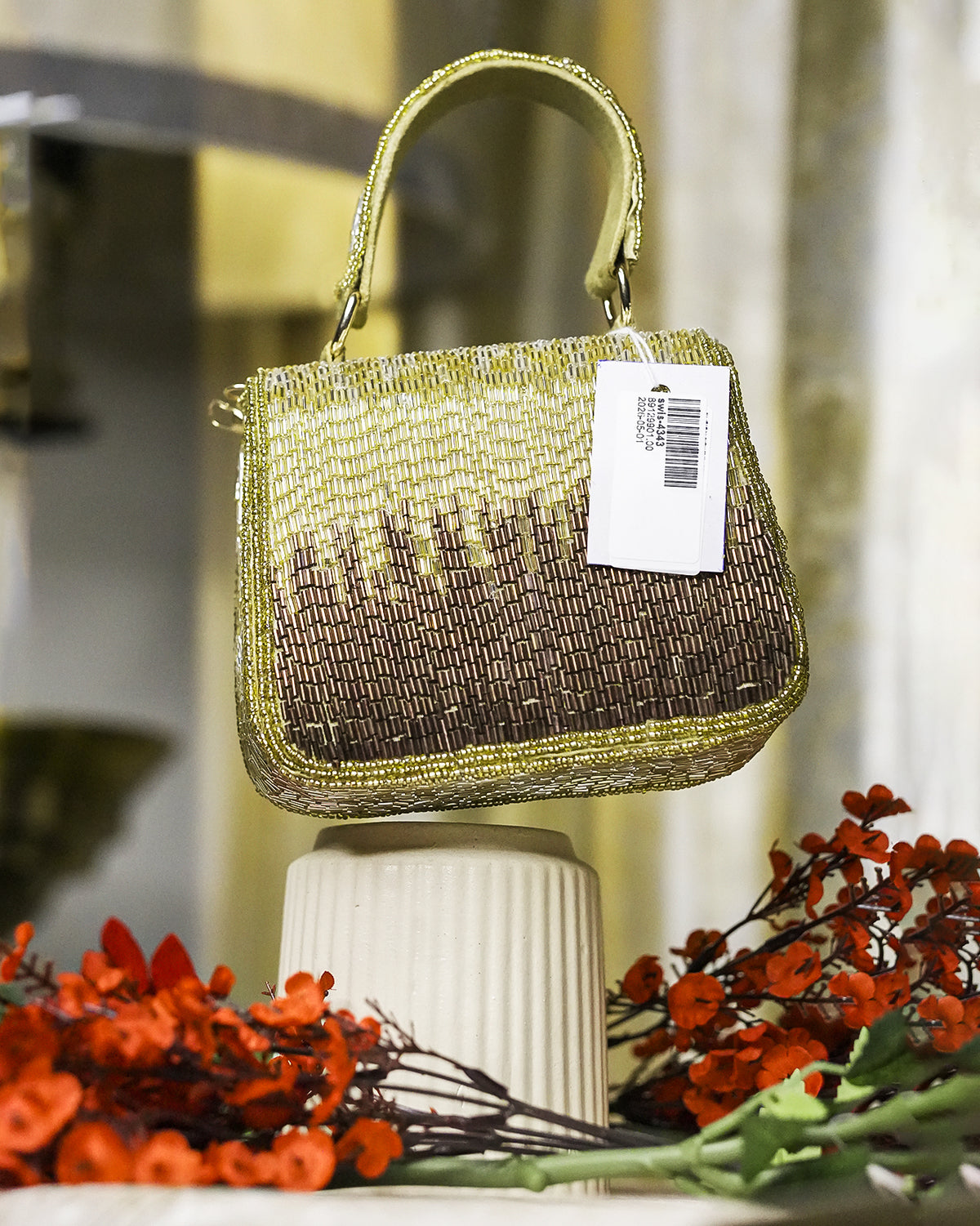 Gold crystal mini bag with top handle and beaded shimmer finish