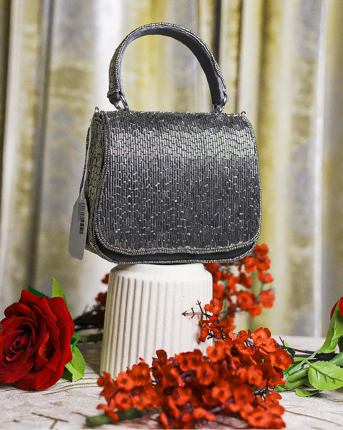 Charcoal beaded crystal mini bag with structured top handle and side tag