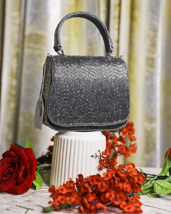 Charcoal beaded crystal mini bag with structured top handle and side tag