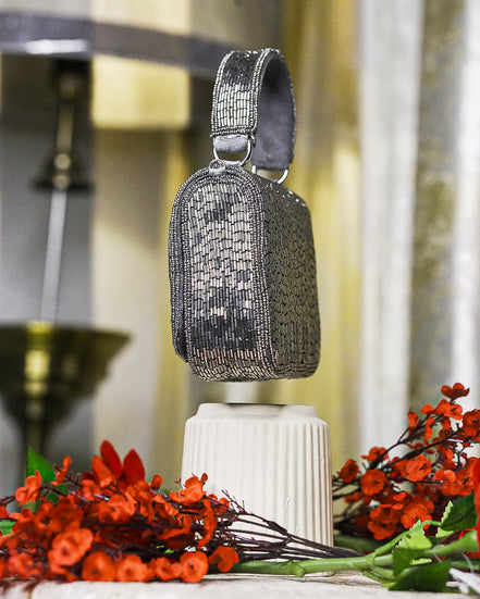 Silver crystal mini bag with top handle and vertical beaded pattern