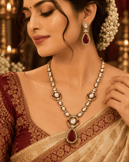 Gold-tone necklace set with red teardrop pendant, pearl beads, and matching drop earrings