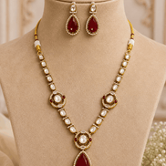 Gold-tone necklace set with red teardrop pendant, pearl bead collar, and matching earrings