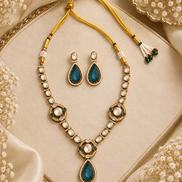 Gold-tone necklace set with green teardrop pendant, pearl bead strands, and stud earrings