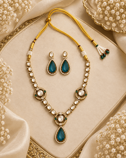 Gold-tone necklace set with green teardrop pendant, pearl bead strands, and stud earrings