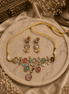 Gold-tone necklace with multicolor teardrop stones and matching earrings set