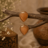 Amber orange teardrop stud earrings with faceted stones