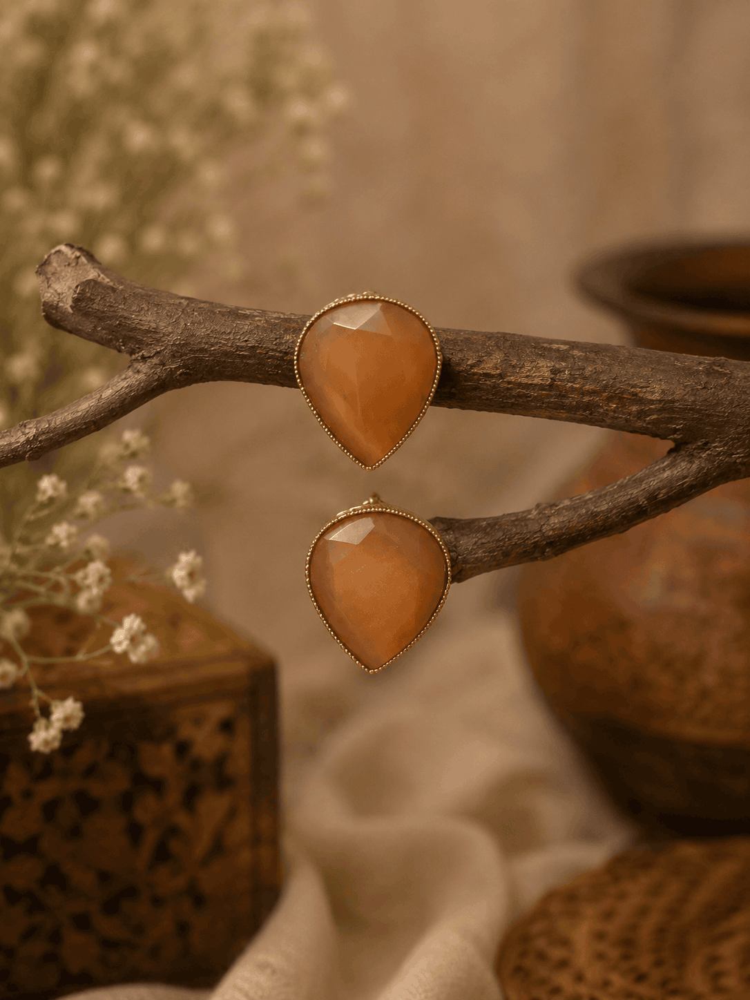 Amber orange teardrop stud earrings with faceted stones