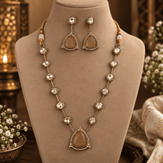 Gold-toned layered necklace with dark red teardrop centerpiece and square bead links