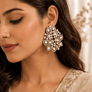 Large pearl and crystal cluster earrings worn by model, gold-tone teardrop detailing