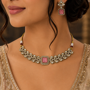 Ruby-pink square-stone choker necklace with gold filigree and stud drop earrings on model.