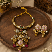 Gold-tone heritage necklace set with yellow thread cord, green and pink pendants, jhumka earrings