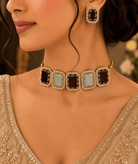 Square enamel statement choker with gold-tone chain and matching stud earrings on model