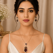 Gold-tone gemstone pendant necklace with matching drop earrings on model