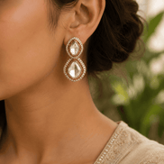 Gold-tone double drop stud earrings with clear oval stones and crystal halo detailing