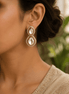 Gold-tone double drop stud earrings with clear oval stones and crystal halo detailing