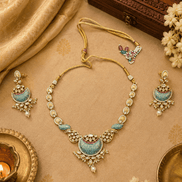 Gold-tone statement necklace with peacock-blue enamel pendant and matching earrings