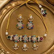 Gold-toned jeweled necklace set with oval maroon-green stones and matching drop earrings.