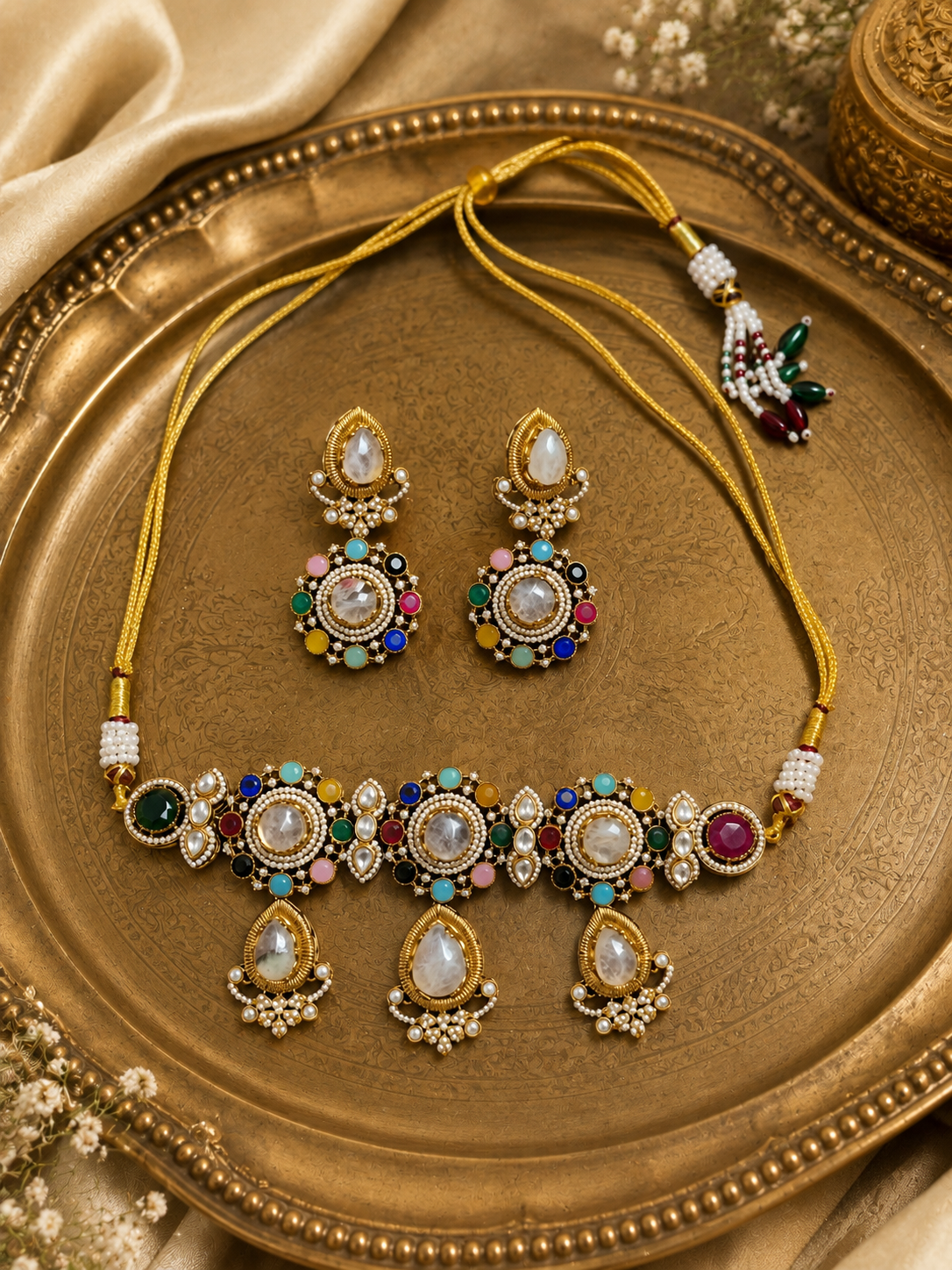 Gold-toned jeweled necklace set with oval maroon-green stones and matching drop earrings.